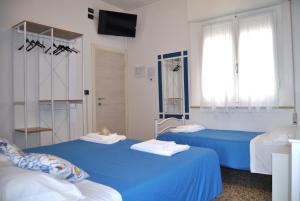 Postel nebo postele na pokoji v ubytování Hotel Susy - Ambienti rinnovati - direttamente su viale Dante e a due passi dal mare