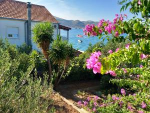 una casa con vistas al agua y a las flores en Apartment Bella, en Trogir