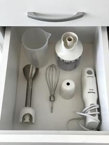 a kitchen drawer filled with kitchen utensils and appliances at Katerina Apartments in Velingrad