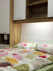 a bed with hello kitty sheets and pillows on it at Katerina Apartments in Velingrad
