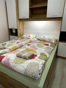 a bed with pillows on it in a room at Katerina Apartments in Velingrad