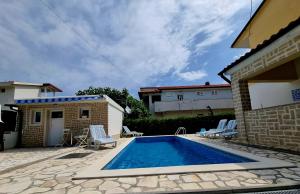 a swimming pool in the backyard of a house at ARA-ZAROK in Baška