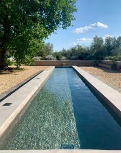 a swimming pool with blue water in a yard at Tenuta Di Paternostro in Vetralla