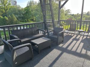 a group of chairs and tables on a patio at Готель Максим Ресторан in Drogovyzhe
