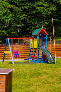 a playground with a slide and a slide at Hotel Vestina in Wisła