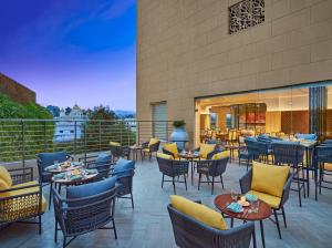 a restaurant with tables and chairs on a patio at Vivanta Jammu City Centre in Jammu