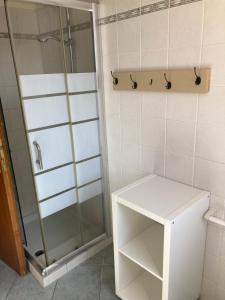 a bathroom with a shower and a white cabinet at Parco Vacanze La Rosa dei Venti in Marina di Bibbona