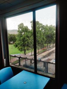 a window in a room with a view of a field at Sukh Sagar Hotel in Jaipur