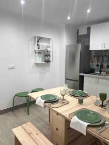 a kitchen with green plates on a wooden table at Casa da Grota do Bravo in Nordeste
