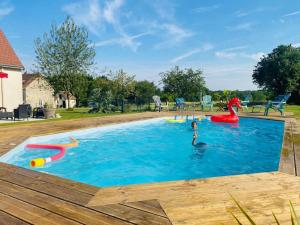 a child swimming in a swimming pool at a playground at Gîte "Chez Paulette" Proche Zoo de Beauval in Mareuil-sur-Cher