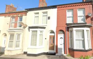 a large white house with a cat on top of it at Air Host and Stay - Daisy House - Large 3 bedroom sleeps 7 10 minutes from city centre in Liverpool