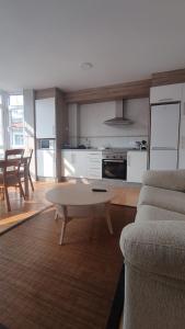 a living room with a couch and a table at Villa Xunqueira 2 in Cee