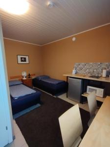 a living room with two beds and a desk at Room for 2 in Šiauliai