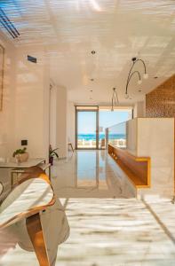 a living room with a view of the ocean at Diamond Star Hotel in Falasarna