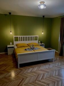 a bedroom with a bed and green walls at HARMONY Apartments in Rajecké Teplice