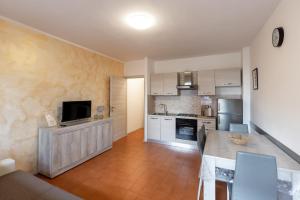 een keuken met een tafel en een televisie in een kamer bij Appartamenti Angelica Ospedale cisanello in Pisa