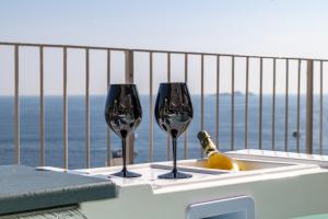 two wine glasses on a table with a bottle of champagne at Villa Nina in Positano