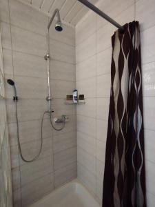 a bathroom with a shower with a shower curtain at Room for 2 in Šiauliai