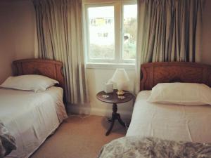 a room with two beds and a table with a window at Seaview Sefton in Timaru