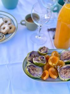 a plate of donuts and oranges on a table at Stecadó Glamping in Dolceacqua