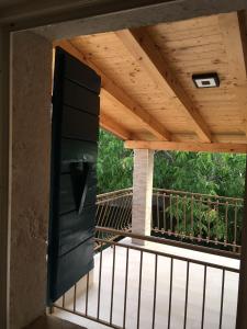 a wooden door on a deck with a wooden ceiling at Art De Lux apartment in Višnjan