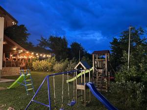 a playground in a yard at night at Casa Petra in Pietrăria
