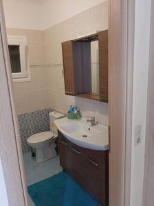 a bathroom with a sink and a toilet at Sissy Villas 2 in Poros Lefkadas