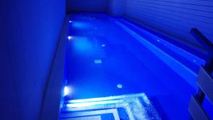 a swimming pool with blue lights in a house at House of Flowers in Rhodes Town
