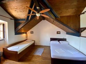 a bedroom with two beds and a ceiling fan at Seaside dream in Trstenik