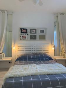 a bedroom with a blue bed with two windows at Gare - Les Champs - 1 SDB privative - parking gratuit in Saint-Brieuc