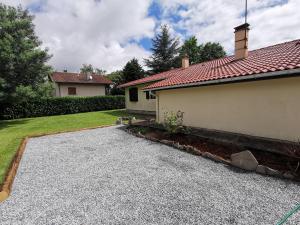a house with a gravel driveway next to a house at Calme entre pins et océan in Onesse-et-Laharie +10 photos
