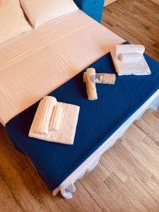 un letto con due asciugamani e due fette di pane di Guest House Napoleone a Carloforte