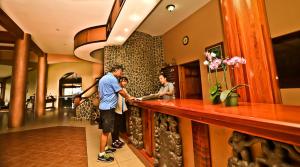 three men standing at a bar in a hotel at Hotel Montaña Monteverde in Monteverde Costa Rica