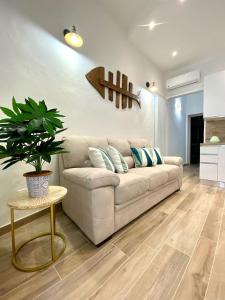 a living room with a white couch and a table at 70mt dal mare in Viareggio