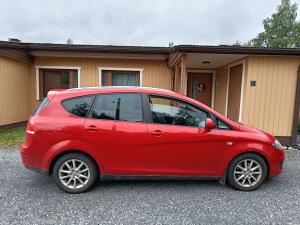 a small red car parked in front of a house at Ristiina Apartment with Sauna in Ristiina