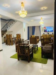 a living room with chairs and tables and a chandelier at SAKURA Guest House Tourist only in Wariyapola