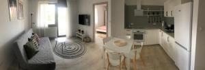 kuchnia i salon ze stołem i krzesłami w obiekcie Apartament Skandynawski w mieście Chojnice
