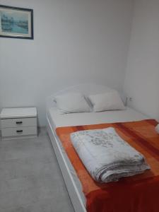 a bedroom with a large bed with a night stand at River Hostel Belgrade in Belgrade
