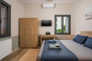 a small bedroom with a bed and a television at Isabella's Hidden Gem House in Chania Town