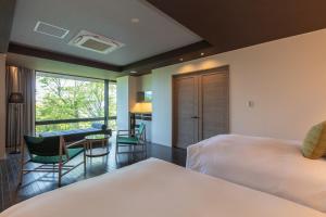 Postel nebo postele na pokoji v ubytování KANAYA RESORT HAKONE