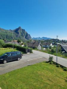 a car parked on the side of a road at Sentral og hyggelig bolig in Svolvær