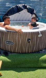 a group of men in an inflatable pool in the water at Dalbo House in Slobozia-Mîndra