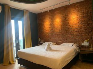 a bedroom with a bed with a stuffed animal on it at Smile Hotel Subang USJ in Subang Jaya