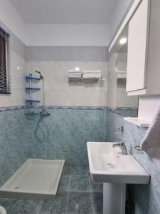 a bathroom with a sink and a shower at Zyli Apts, BY Bunker Art 2 Museum, Tirana in Tirana
