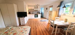 a kitchen and dining room with a table and a television at Casa Wiesenblick in Nürtingen