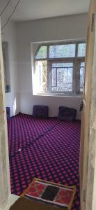 ein leeres Zimmer mit zwei Stühlen und zwei Fenstern in der Unterkunft POP Masrat Homestay 