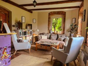 a living room with a couch and a table at Przytulne Siedlisko in Jugowice