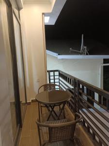 a table and two chairs on a balcony at TWINS VILLA SUITES KIGALI in Kigali