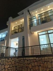 a large white building with balconies at night at TWINS VILLA SUITES KIGALI in Kigali