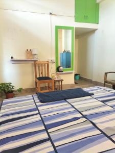 a room with a blue and white rug on the floor at Cozy Homestay AC 400 per day in Guwahati